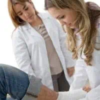 doctor taking care of accident victim with no health insurance
