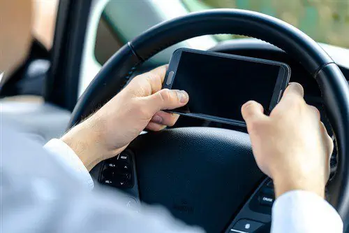 male car driver using his phone for texting while driving accident lawyer Austin