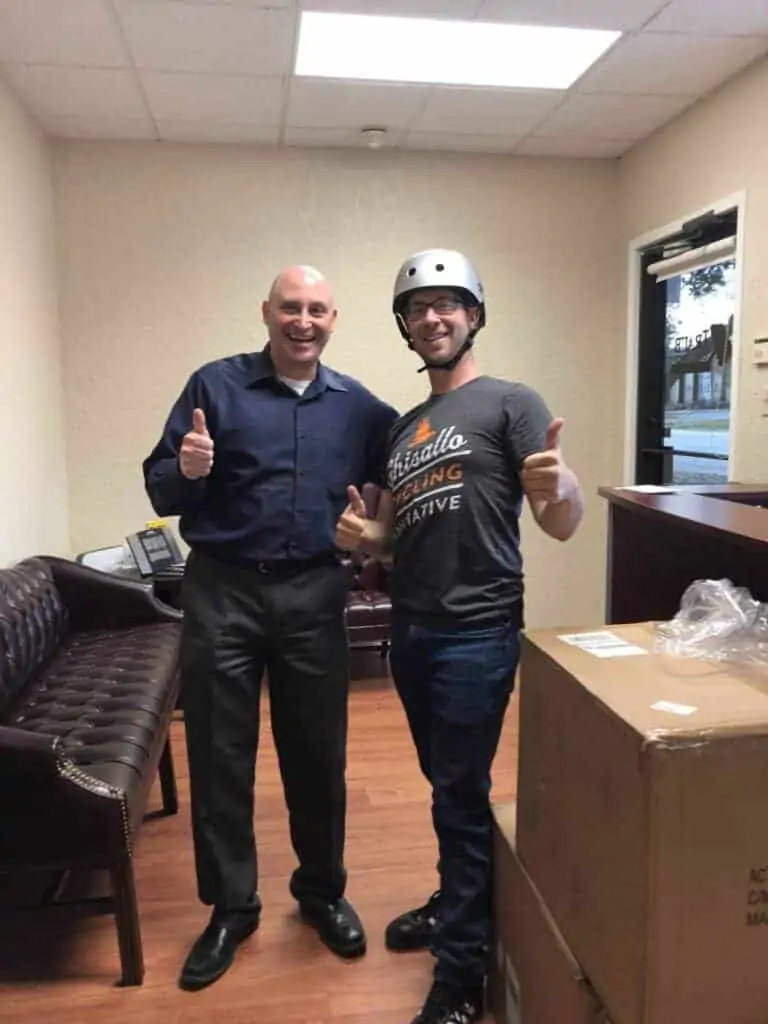 Andrew Traub donating bicycle helmets