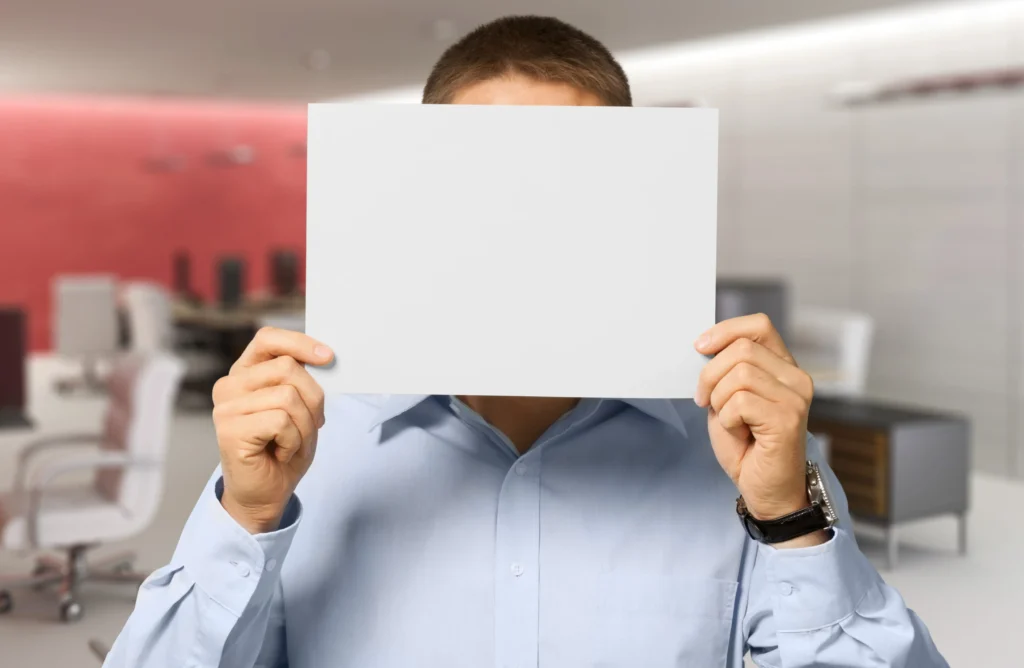 man holding a blank white paper
