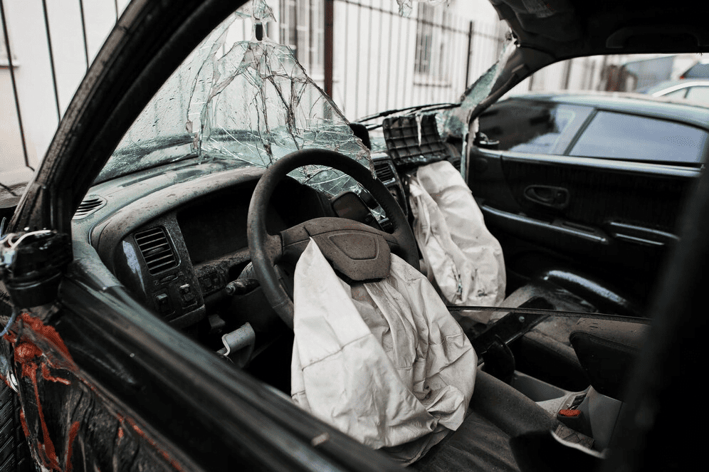 Airbag defect accident lawyer Austin inspecting busted airbag resulting from car accident