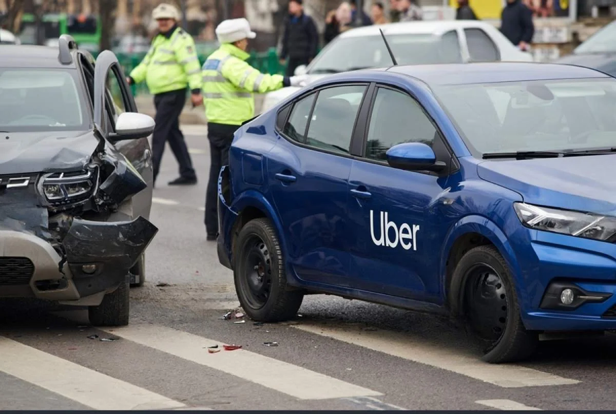 Uber vehicle collides with another car on road, showing crash damage. Rideshare liability, auto insurance claim, and personal injury concept.