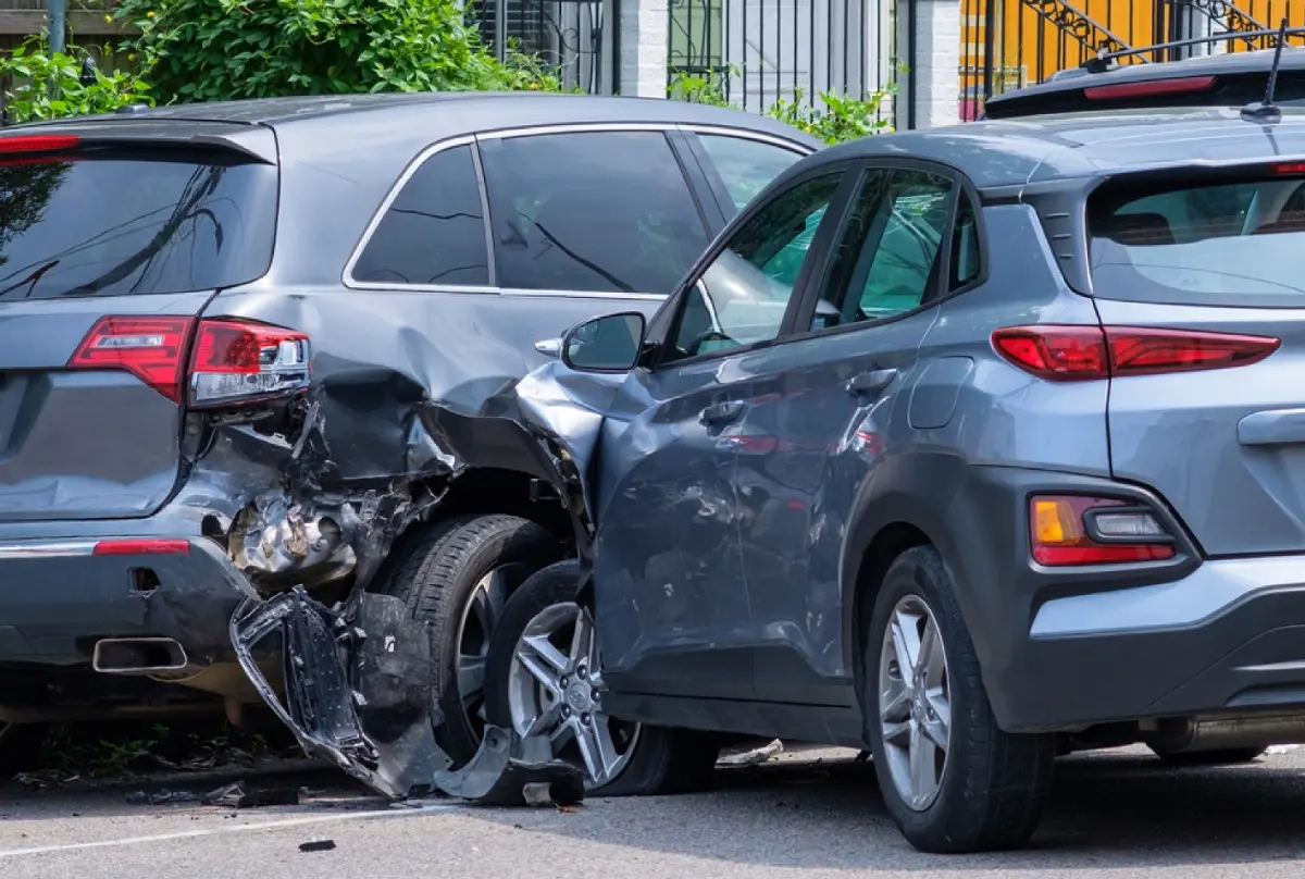 Two-vehicle collision in the crosswalk, posing a danger to pedestrians, relevant for personal injury claims.