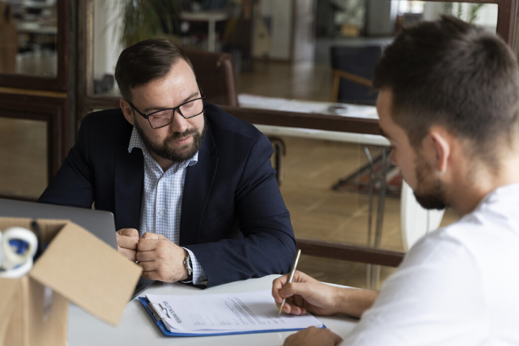 A man consulting with a lawyer about the types of product defects.
