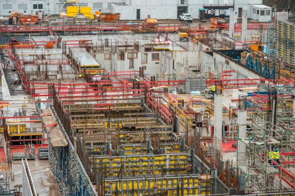 Aerial view of an active construction site with scaffolding and rebar